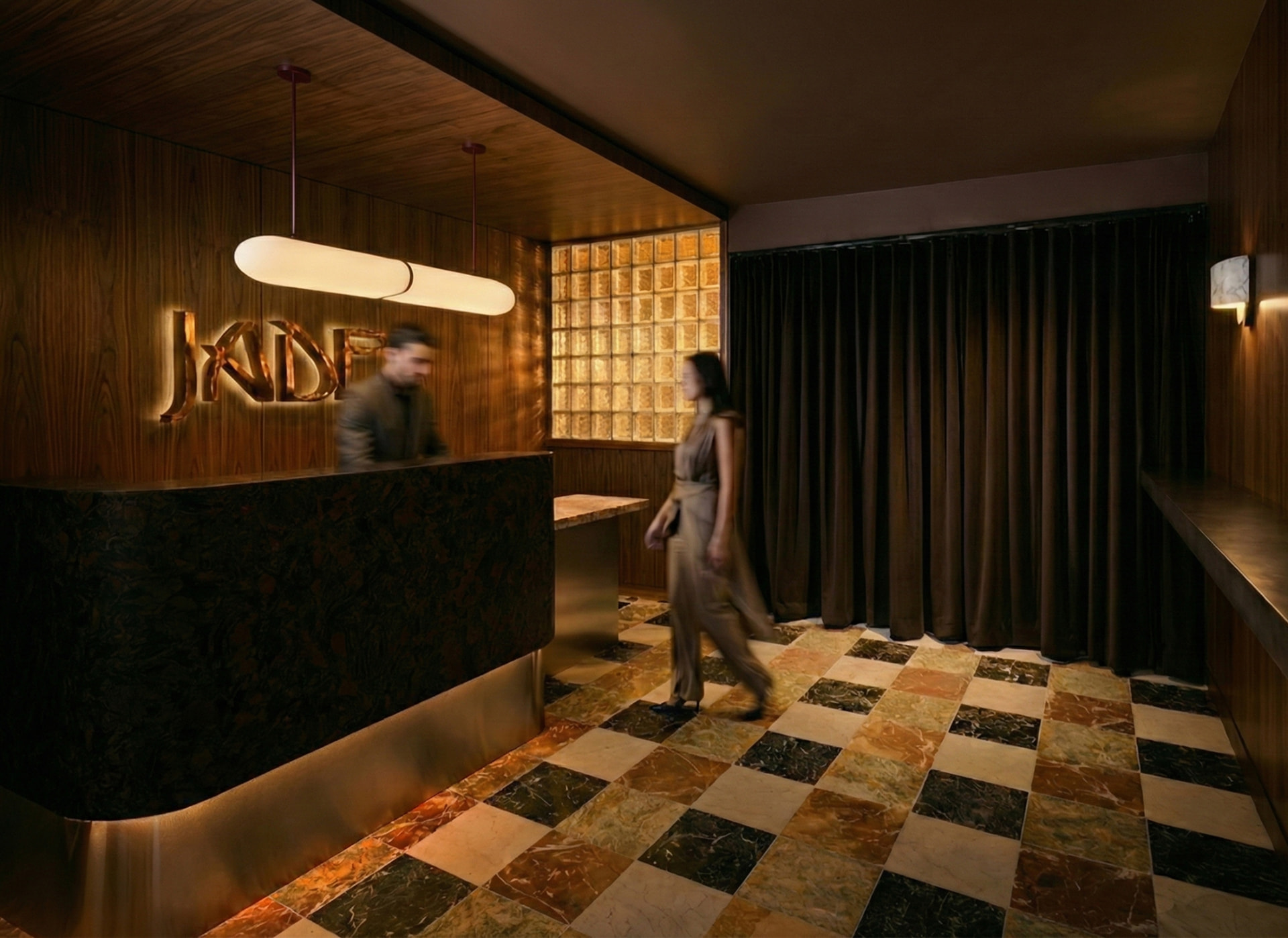 JADE lobby with dark curtains, glass block, and marble floor
